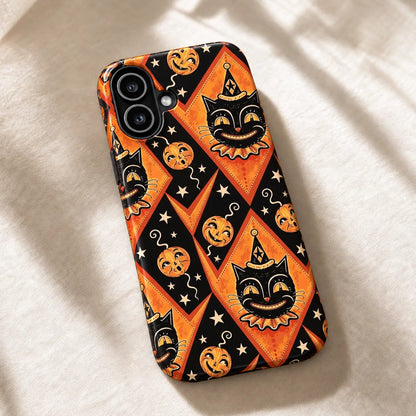 Vintage Halloween Joker Cat iPhone case resting on cream fabric, with orange diamonds and cream stars