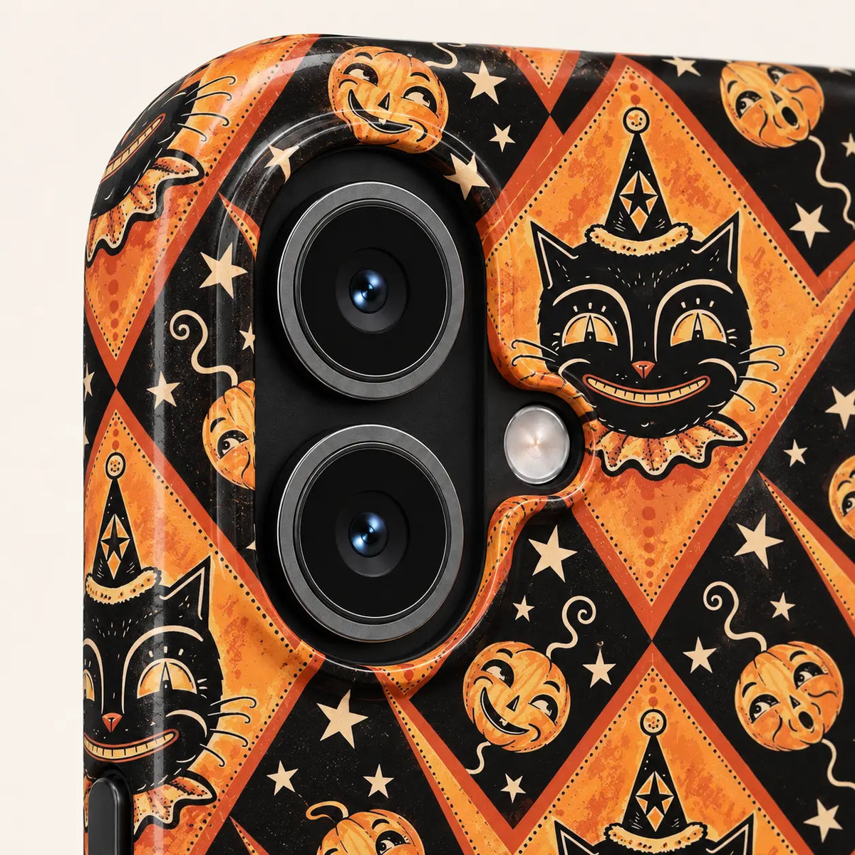 Close-up of the iPhone camera opening surrounded by Joker Cat illustrations, orange pumpkins and cream stars